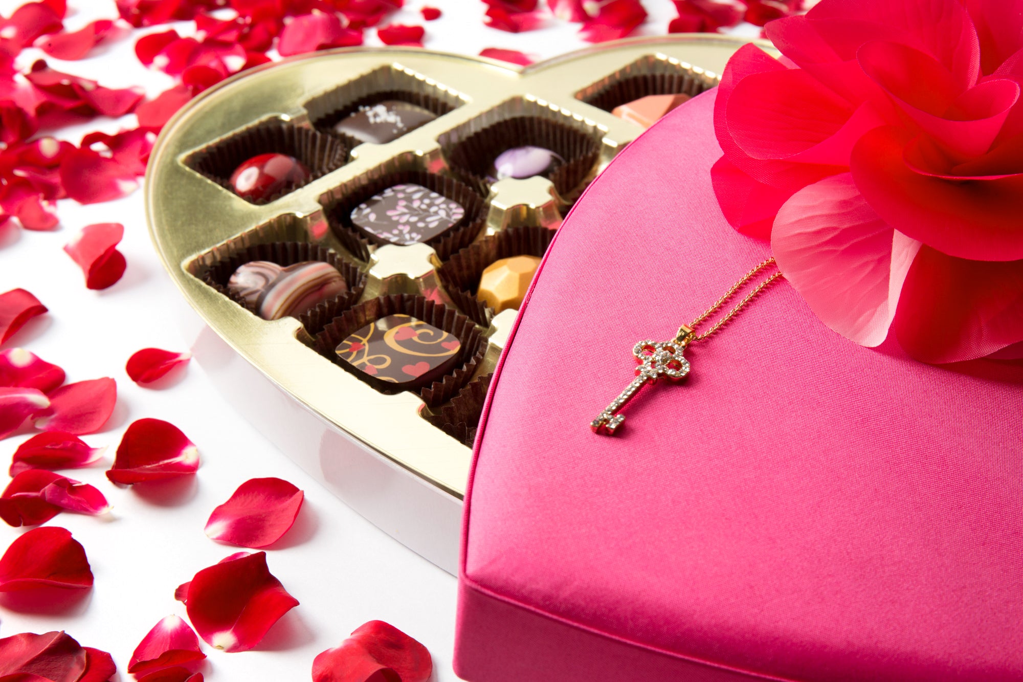 Pink heart shaped box of chocolates with rose petals from St. Croix Chocolate Company